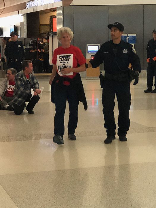 Conny Ford, a San Francisco Labor Council vice president is arrested while protesting for better pay for workers. Her T-shirt reads "One job should be enough." (Photo courtesy of Conny Ford)