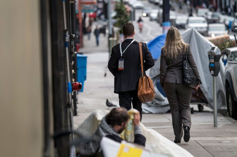 Pedestrians walk past the homeless in the Tenderloin. (Photo courtesy of David Paul Morris/Bloomberg. Jan. 13,2020)