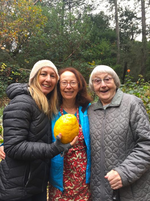 Wade, center, with friends and a giant lemon she grew in Sonoma. (Photos courtesy of Isabel Wade.)