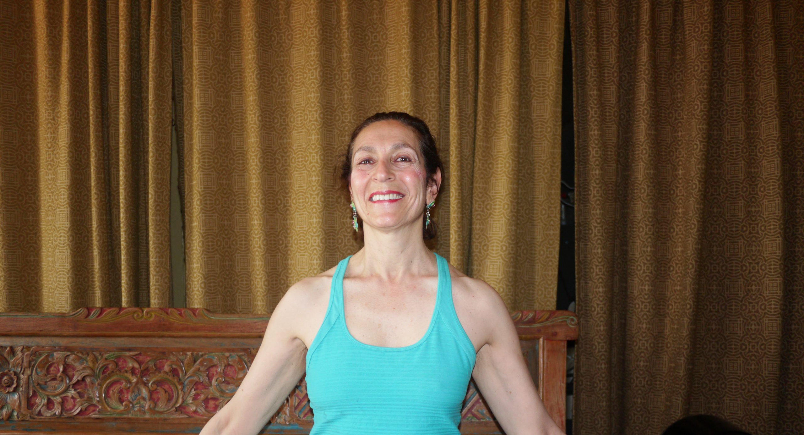 Dance professional uses light touch, eye contact and dialogue to guide seniors and those with disabilities through yoga movements