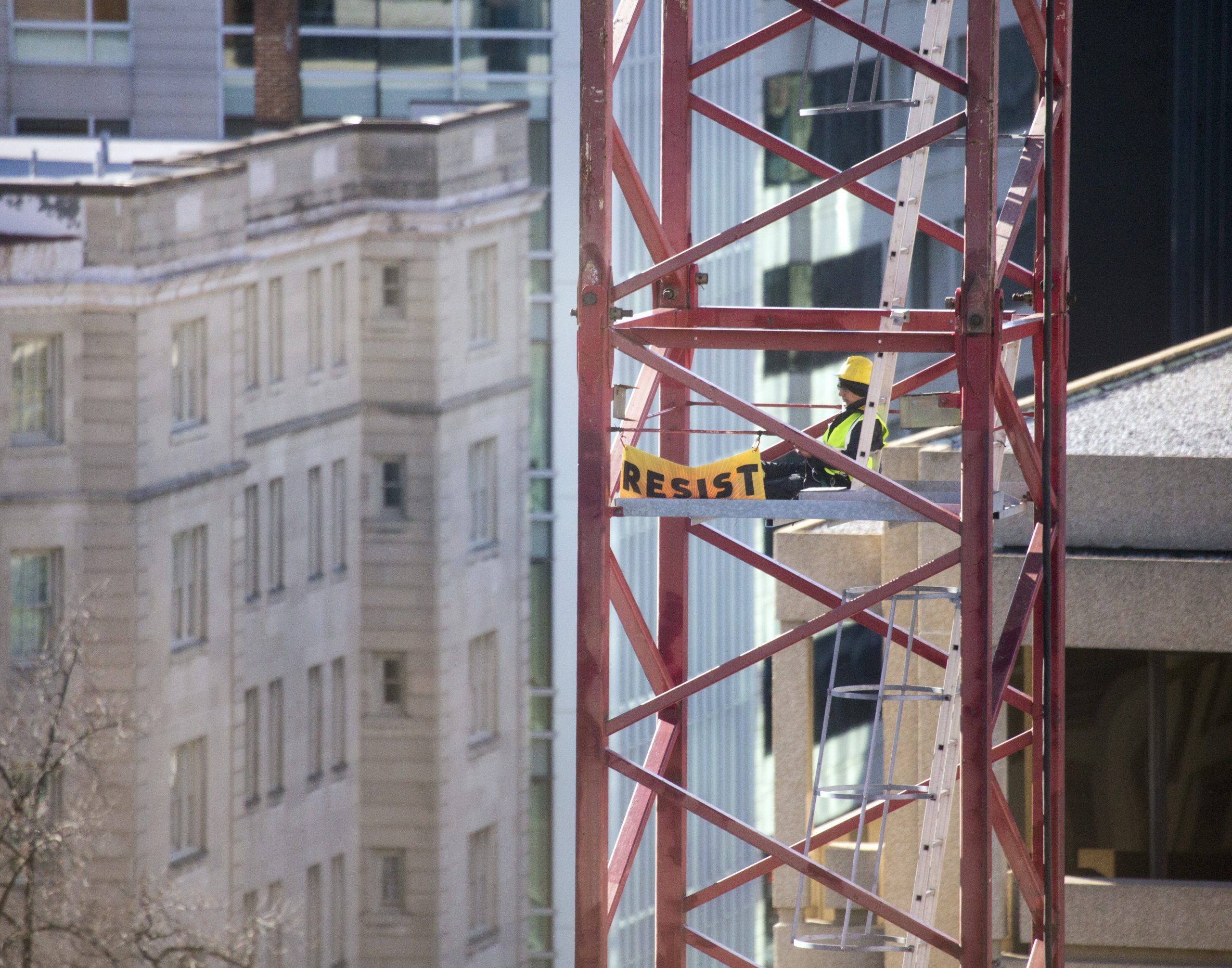 Greenpeace activists deploy a banner on a construction crane near the White House in Washington, D.C., Jan. 25, 2017, reading "RESIST" on President Trump's fifth day in office.The activists are calling for those who want to resist Trump's attacks on environmental, social, economic and educational justice to contribute to a better America.