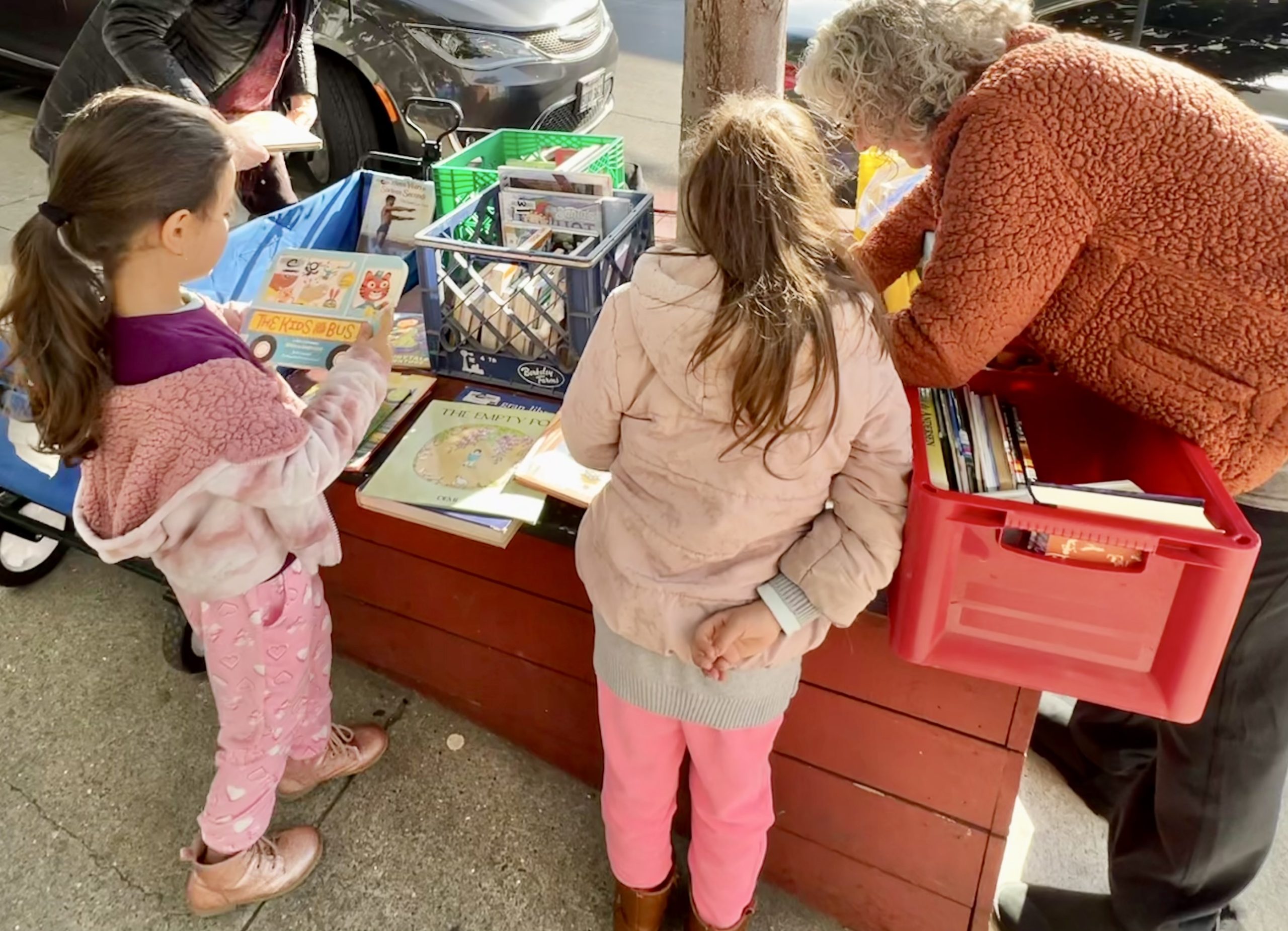 Colorful crates carry arts and communications retiree's tools to better the brains of children