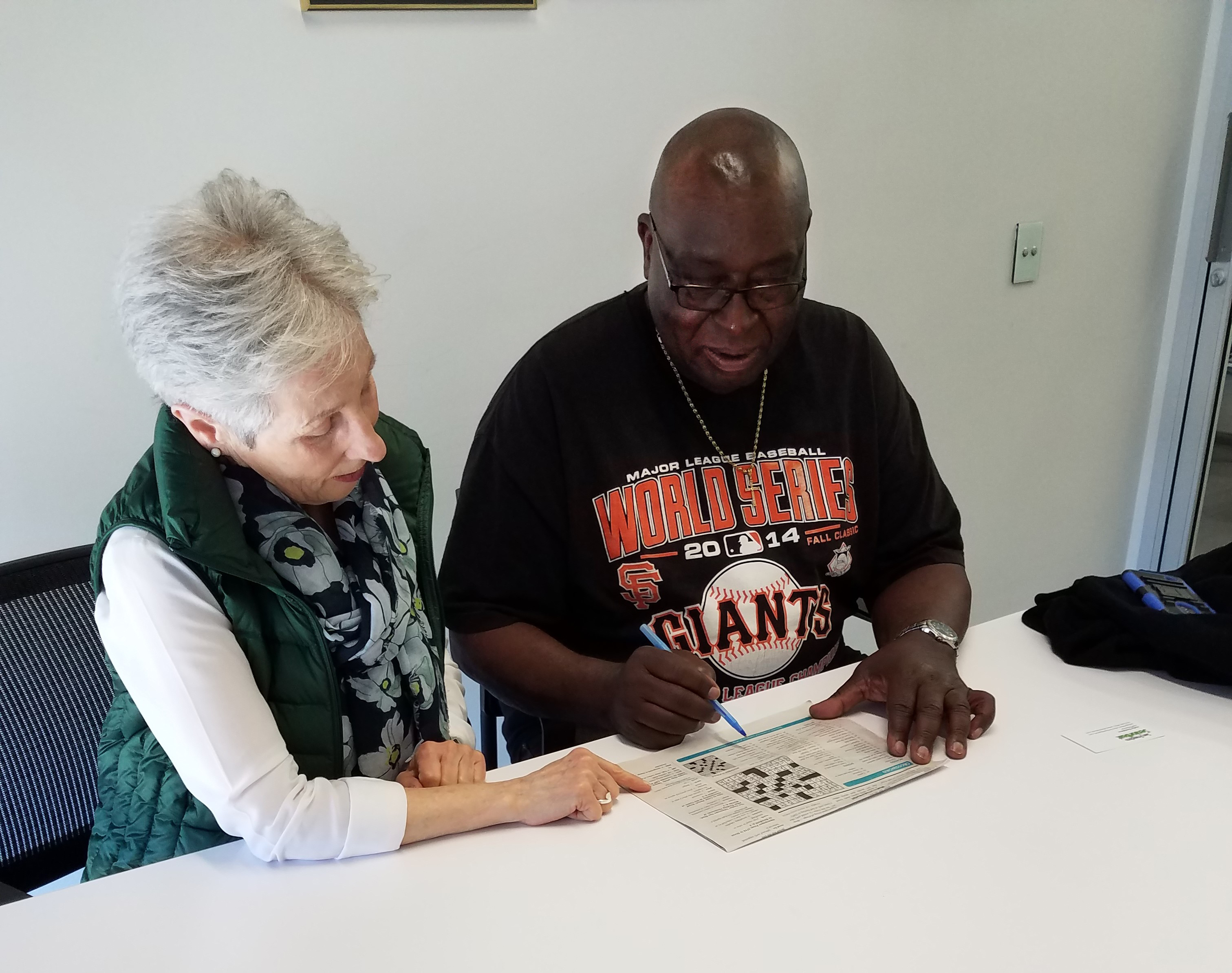 Project Read tutor Arleen Godwin works on a crossword puzzle with Ollie Smith. Photo by Judy Goddess.