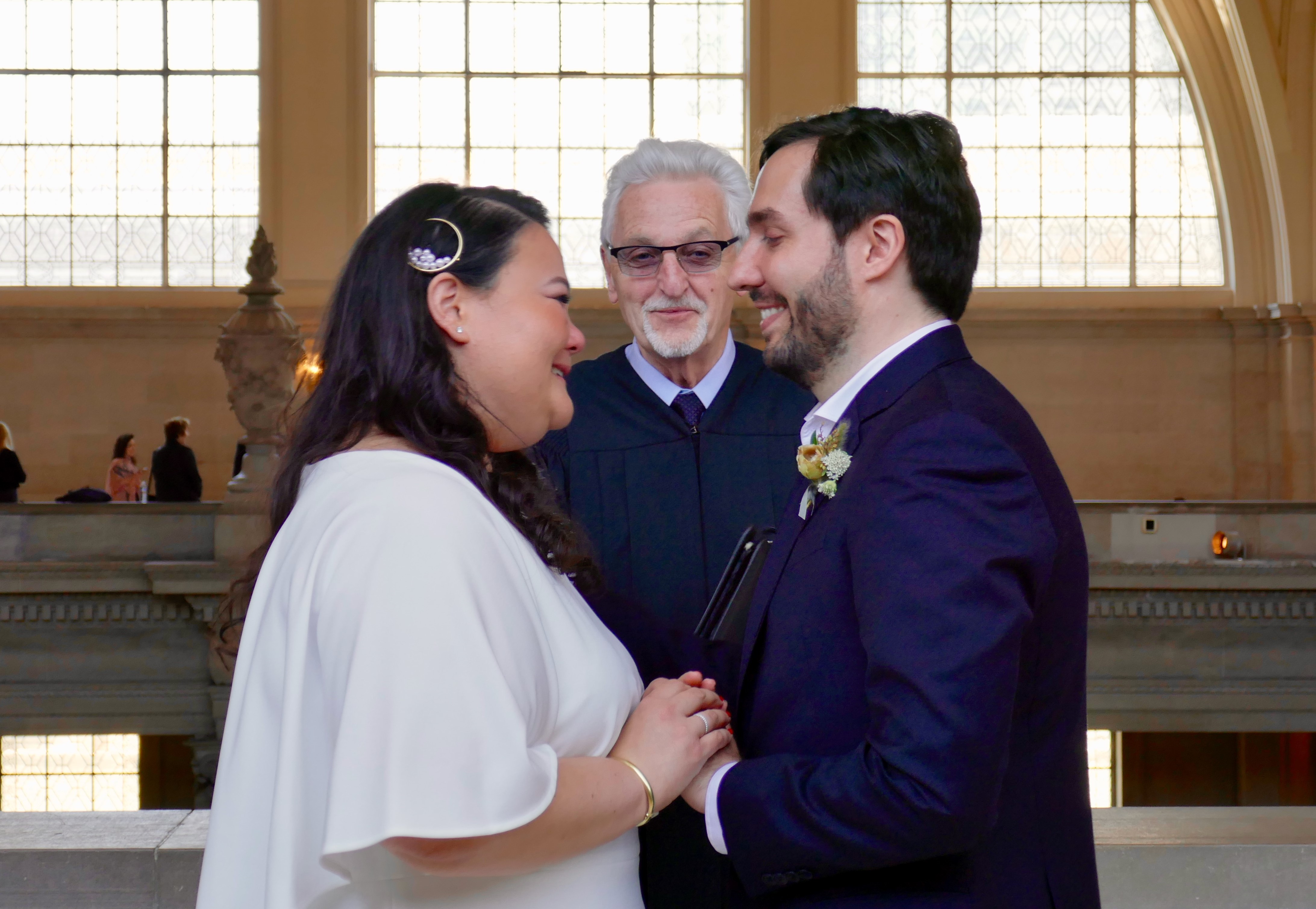 Jim Illig, who has conducted 13,000 weddings at City Hall in the last 26 years, joins Wendy & Daniel Parker in marriage. Photo by Kate Kuckro.